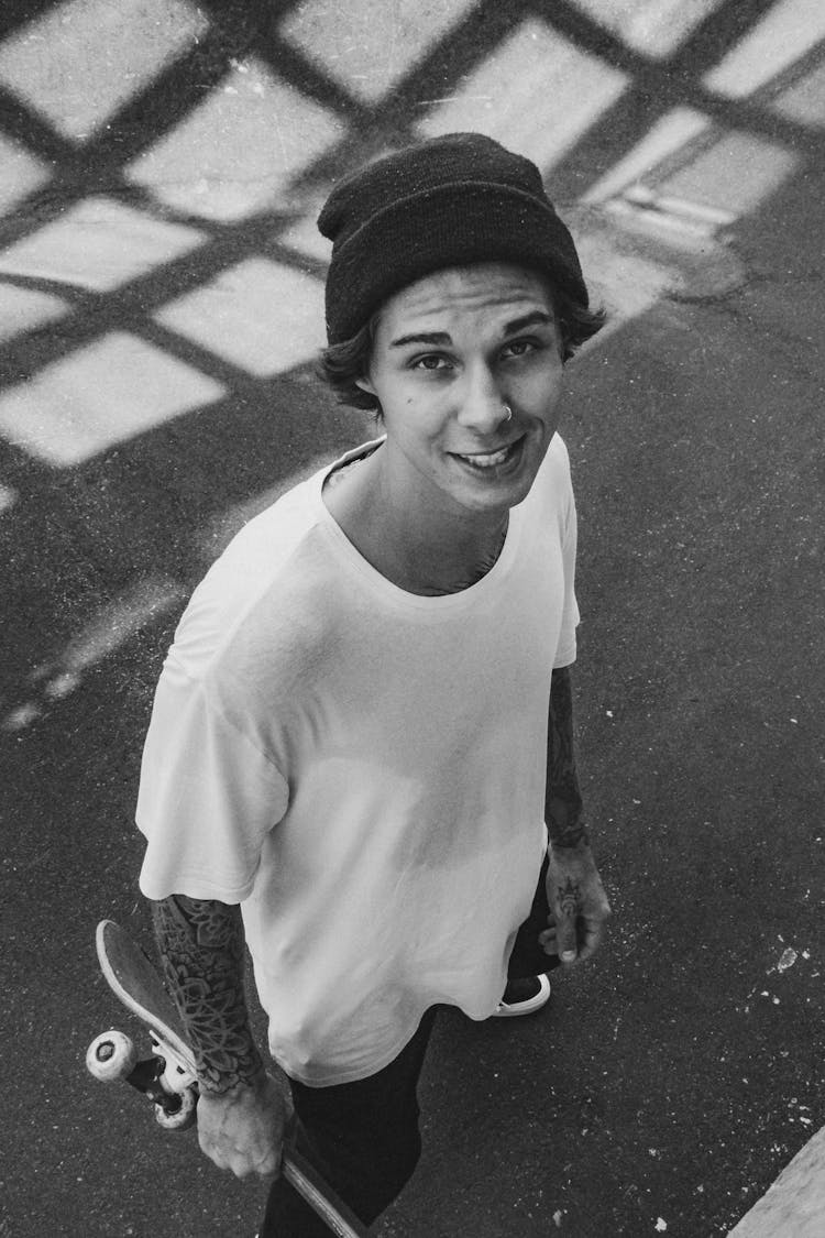 Young Man Holding A Skateboard 