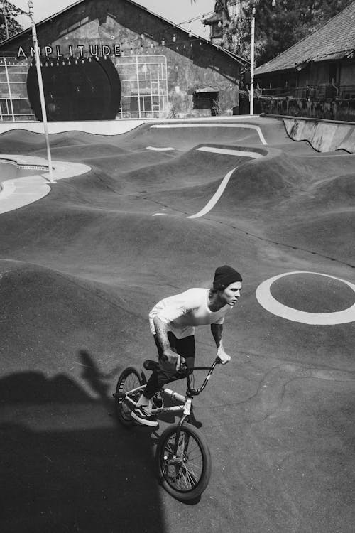 Man Riding Bicycle in Skatepark