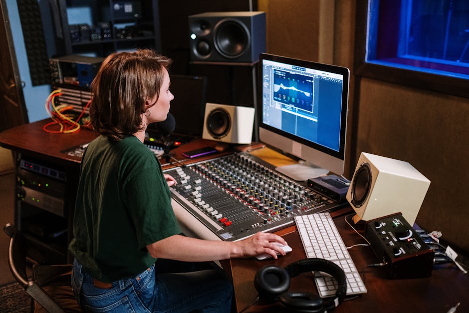Top Smart Speaker Sound Quality Rankings for 2025: Ultimate Guide Woman in studio working on sound mixer and computer, focused on audio editing.