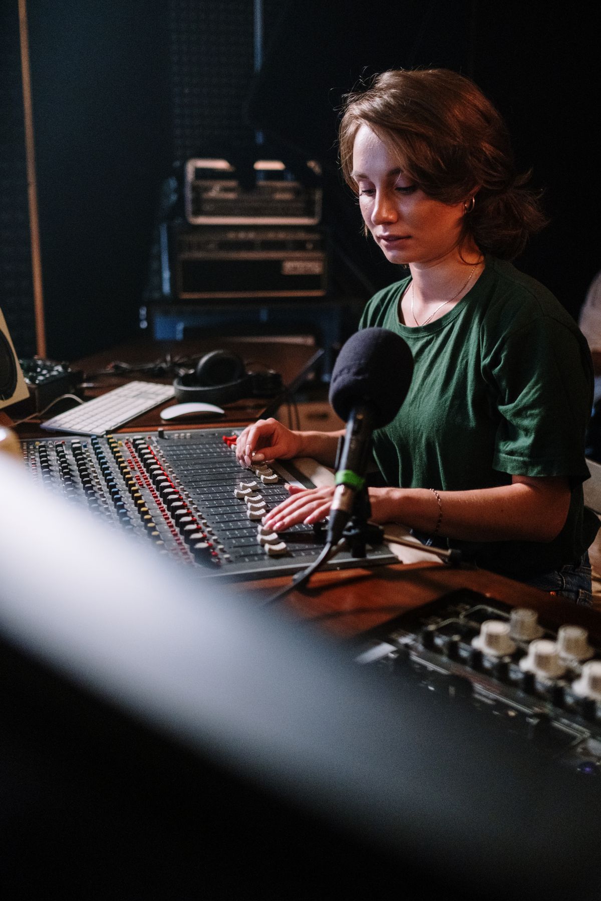 Producer working at an audio mixer in a recording studio