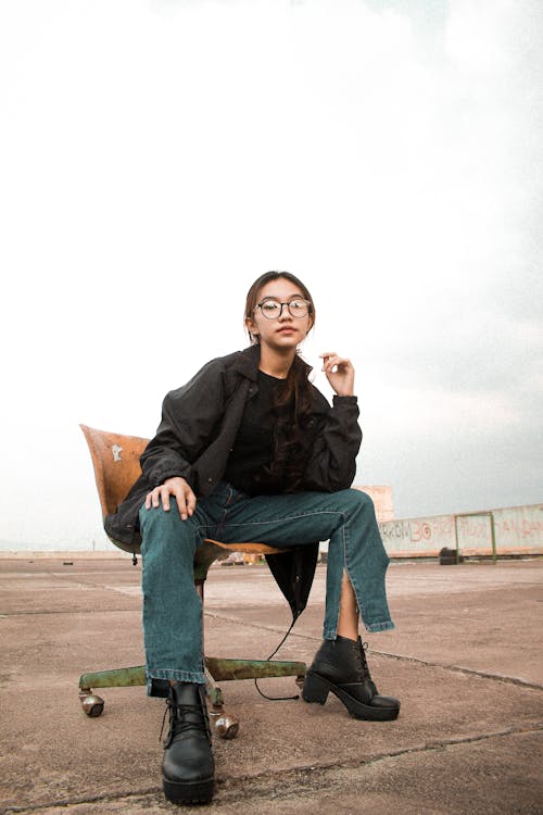 Girl Wearing Eyeglasses Sitting on Wooden Desk Chair 