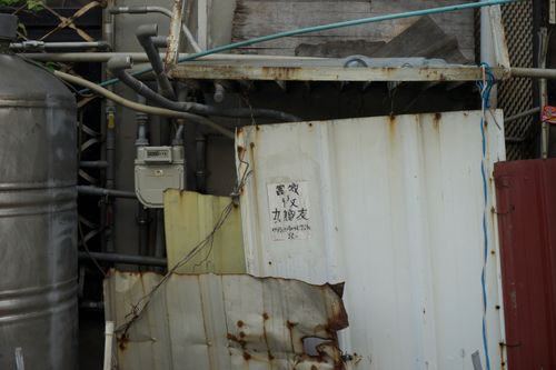 Free Close-up of rusty metal panels and exposed industrial pipes in an urban area. Stock Photo