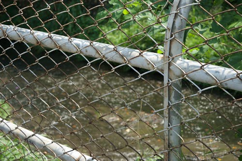 Rusty Metal Fence Near Water