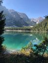 Green Lake Surrounded by Green Trees and Mountains