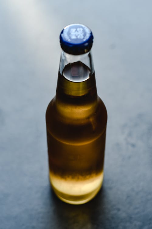 Free Close-Up Shot of a Clear Bottle of Beer Stock Photo