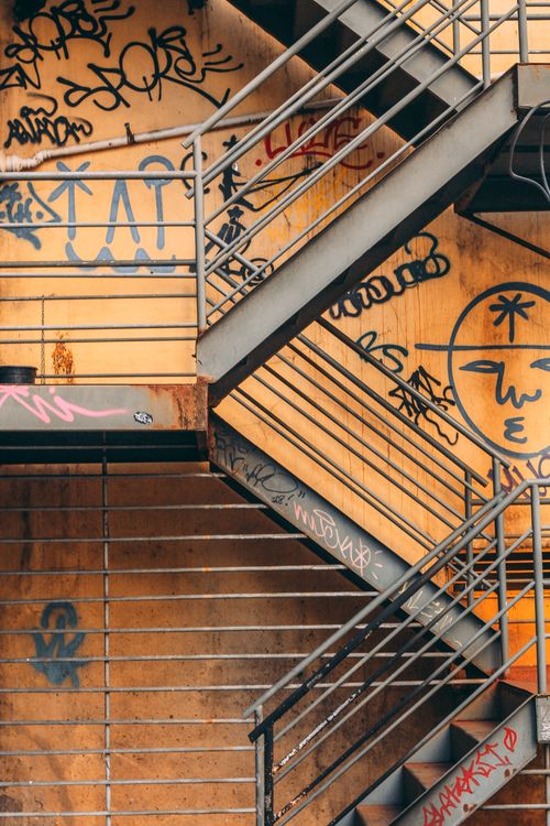 Free Close-up of a graffiti-covered metal fire escape in Rio de Janeiro, showcasing urban culture and architecture. Stock Photo