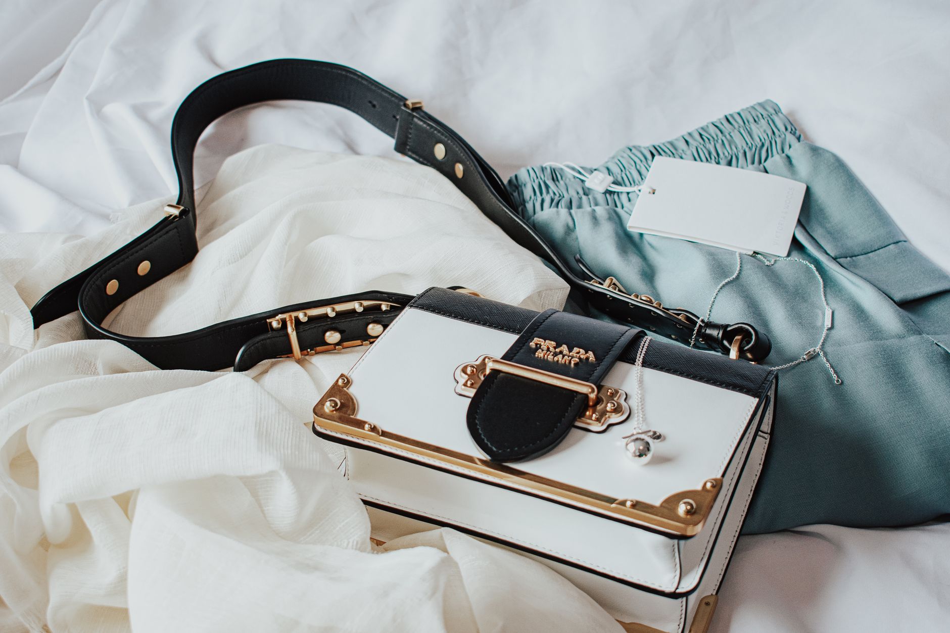 Elegant handbag paired with stylish clothing on a soft backdrop, ideal for fashion inspiration.