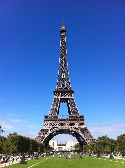 Free A stunning view of the Eiffel Tower under a clear blue sky in Paris, France. Stock Photo