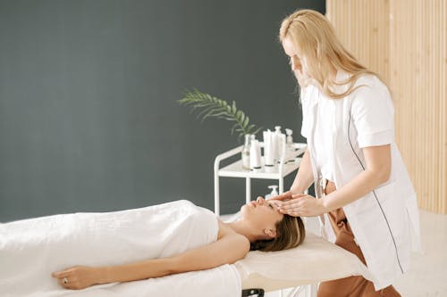 Free A Woman Doing Head Massage Stock Photo
