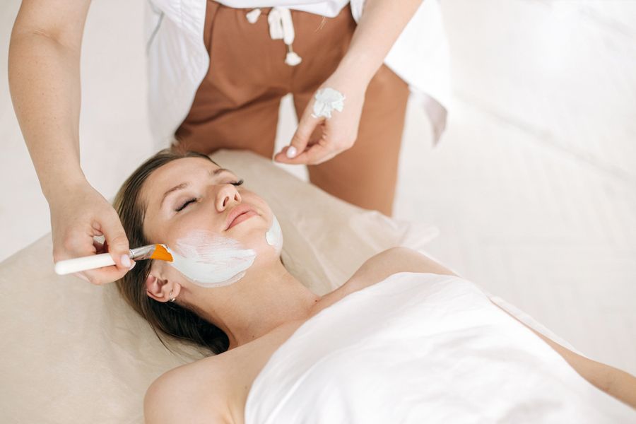 Personalised facial mask being applied by a beautician