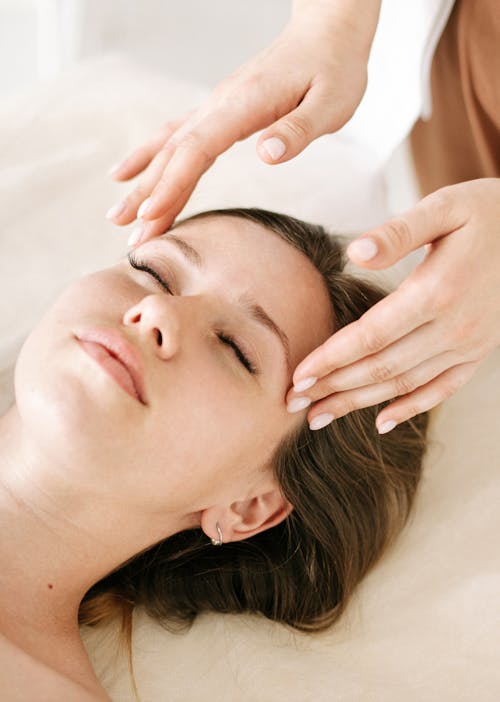Free A Woman Eyes Closed Having a Head Massage Stock Photo