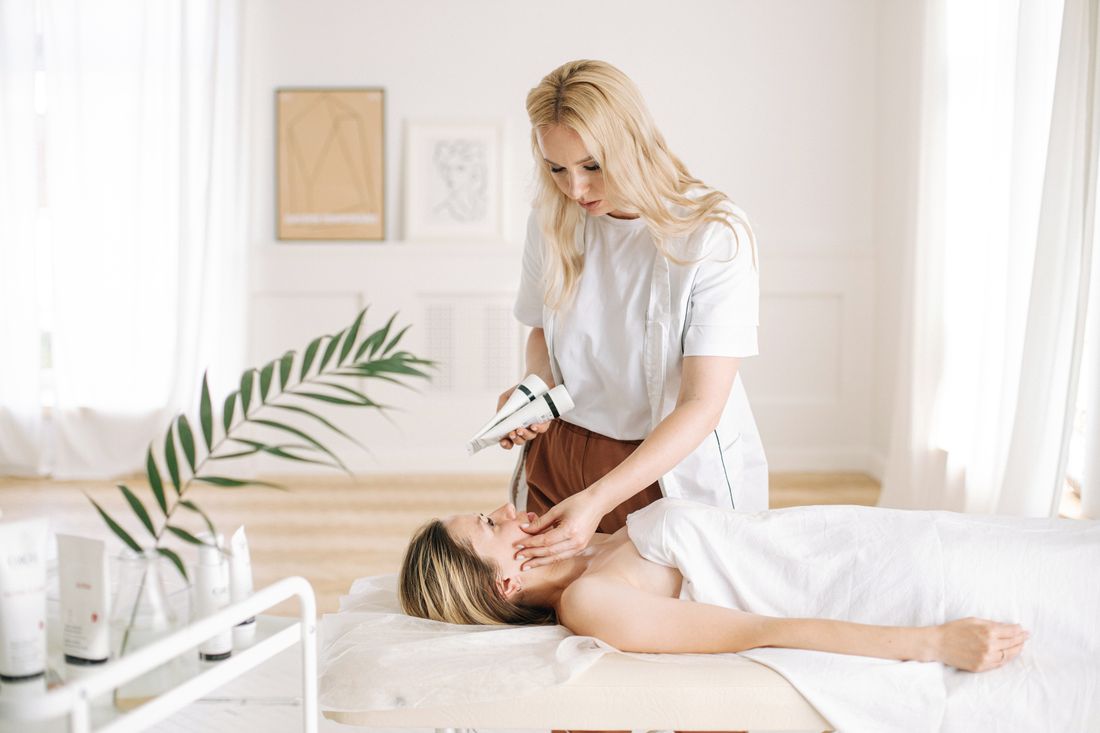 Doctor assessing skin before selecting a skin booster treatment
