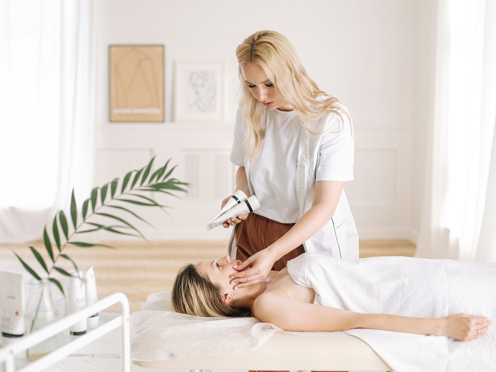 Aesthetic clinician providing a facial treatment in a calm clinic