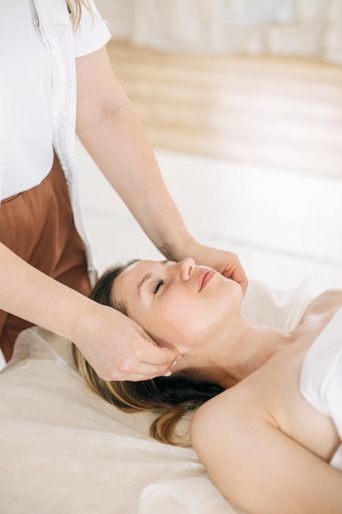  A Person Massaging Woman's Face 