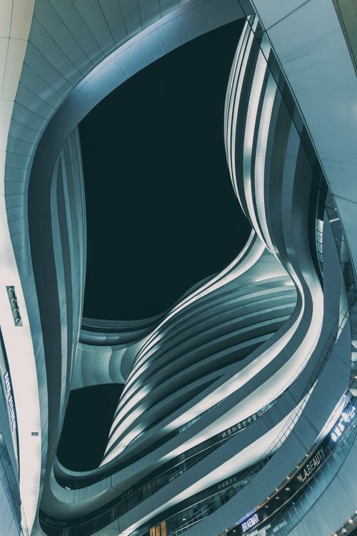 Free Low angle view of modern Milky Way Soho in Beijing at dusk. Futuristic curves and lines in dramatic urban setting. Stock Photo