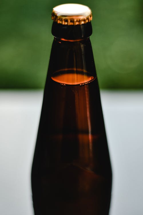 A Beer Bottle with Cap in Close-up Shot 