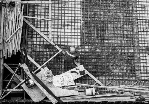 Free High angle view of a worker at a construction site captured in black and white. Stock Photo