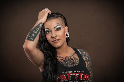 A Woman with Nose Piercing and Tattoos