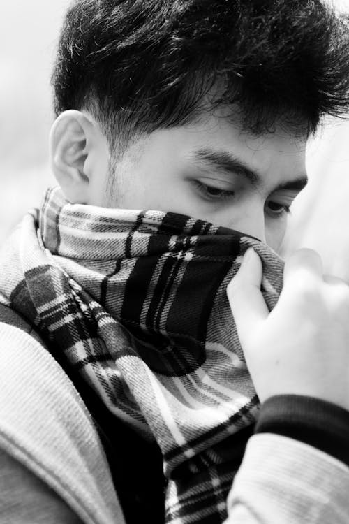 Free Black and White Portrait of Man Covering Face with Scarf Stock Photo