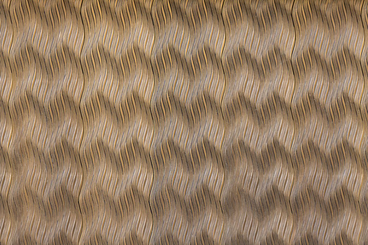 high resolution image of a complex golden zigzag patterned fabric text