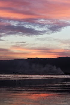 Vibrant sunset over Bertioga beach, capturing the scenic beauty and tranquil ocean reflection.