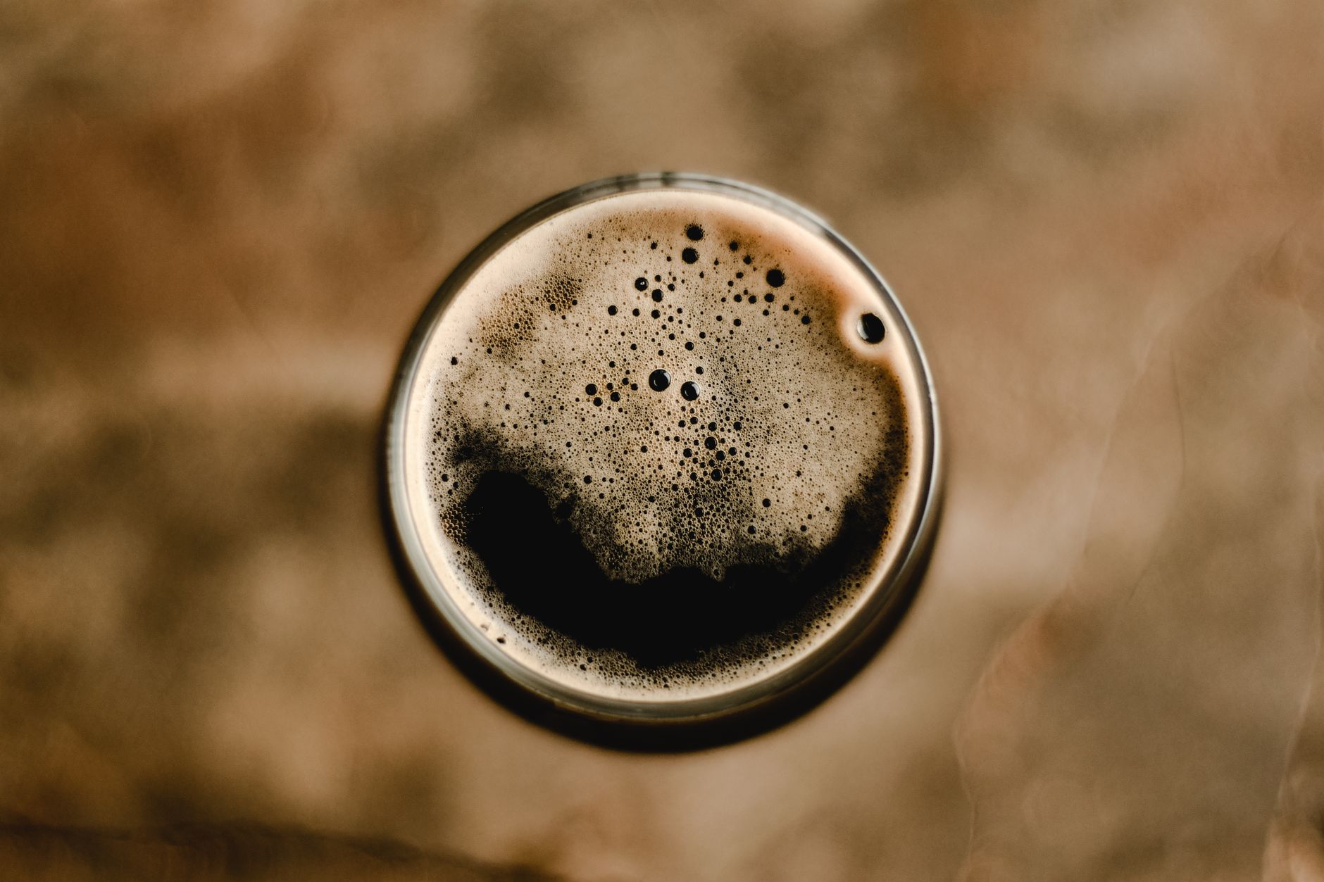 Pouring a creamy stout beer with a thick head