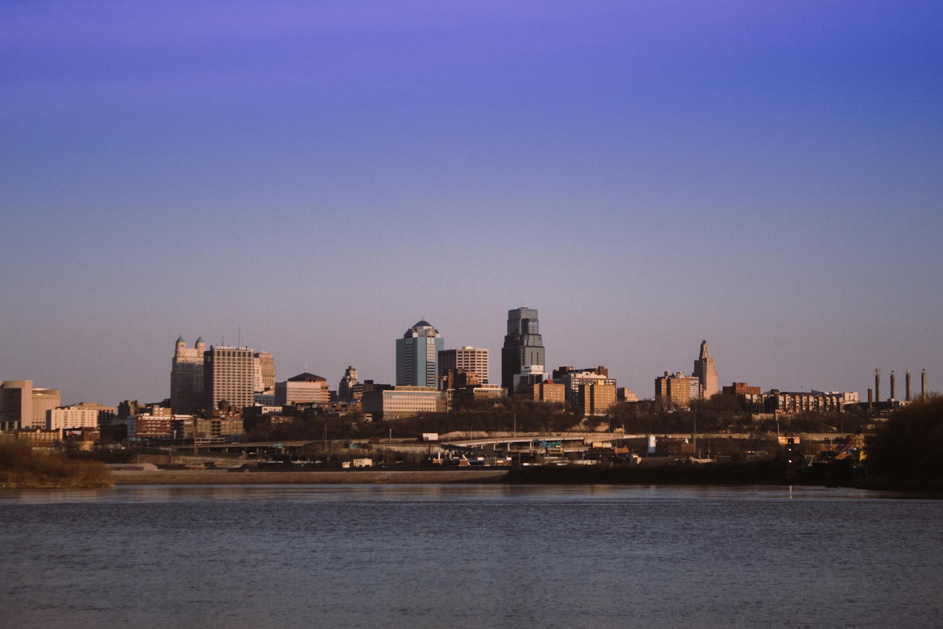 Stunning view of Kansas City skyline captured from Kaw Point Park under a clear blue sky.