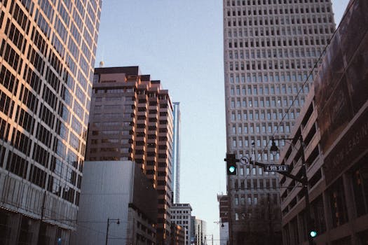 A serene view of Kansas City's high-rise buildings on 9th Street at dusk, showcasing urban architecture.