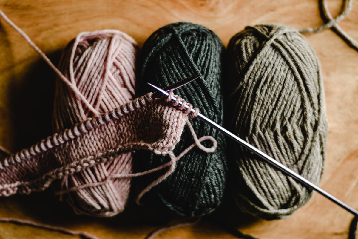 Colorful yarn balls and knitting needles for a craft project