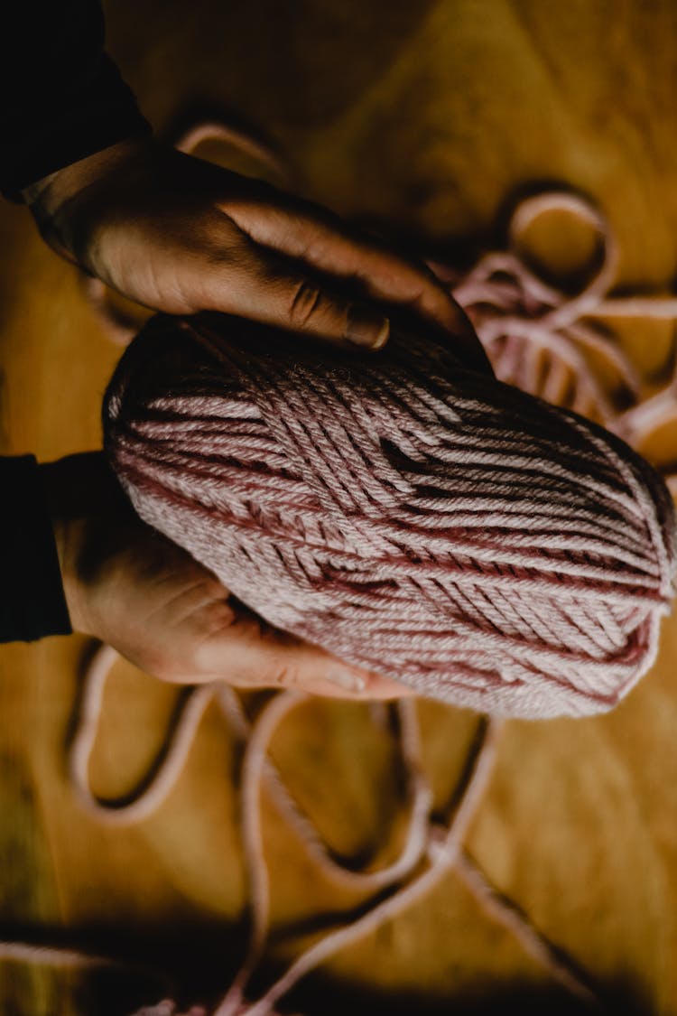 A Person Holding A Yarn 