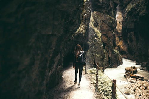 Woman Standing Inside Cavern
