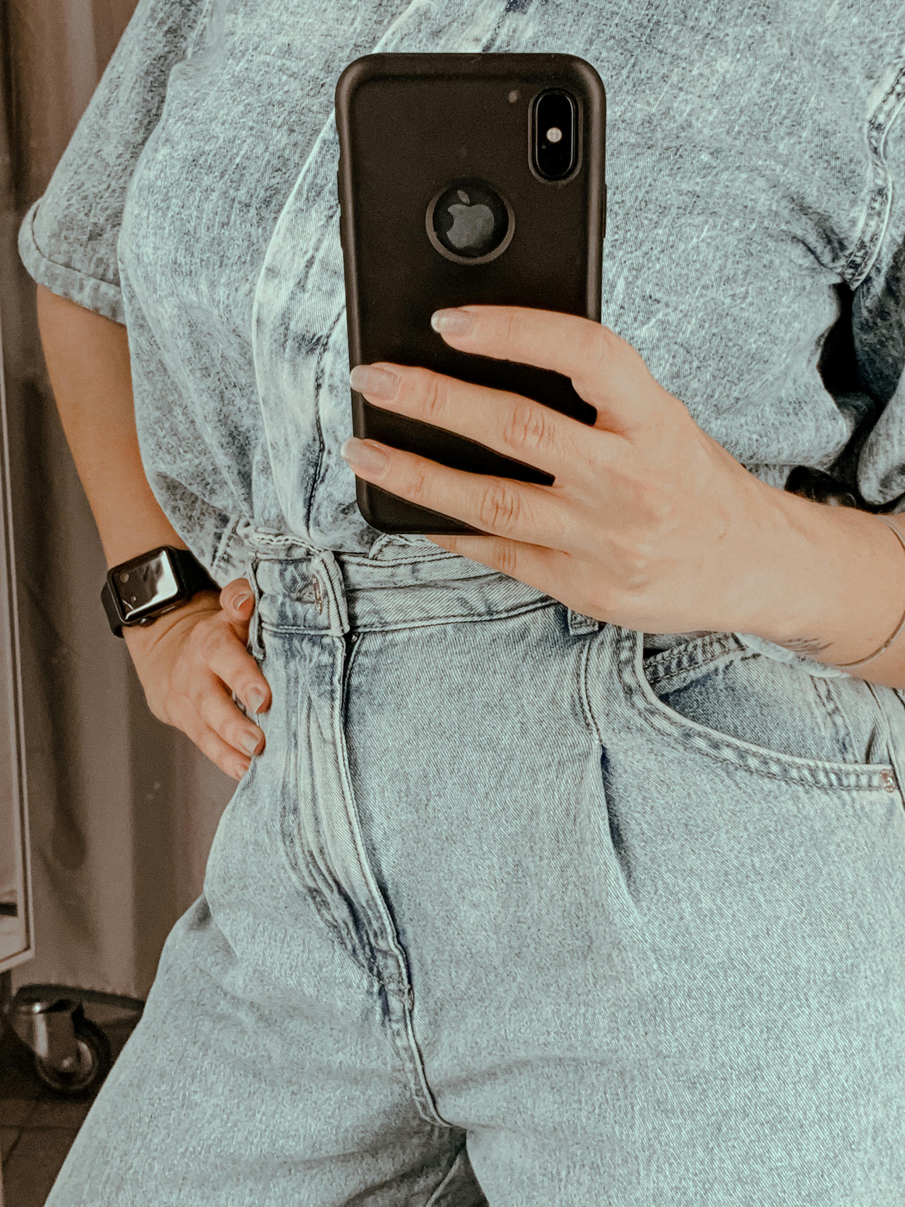 Faceless female with phone taking mirror selfie · Free Stock Photo