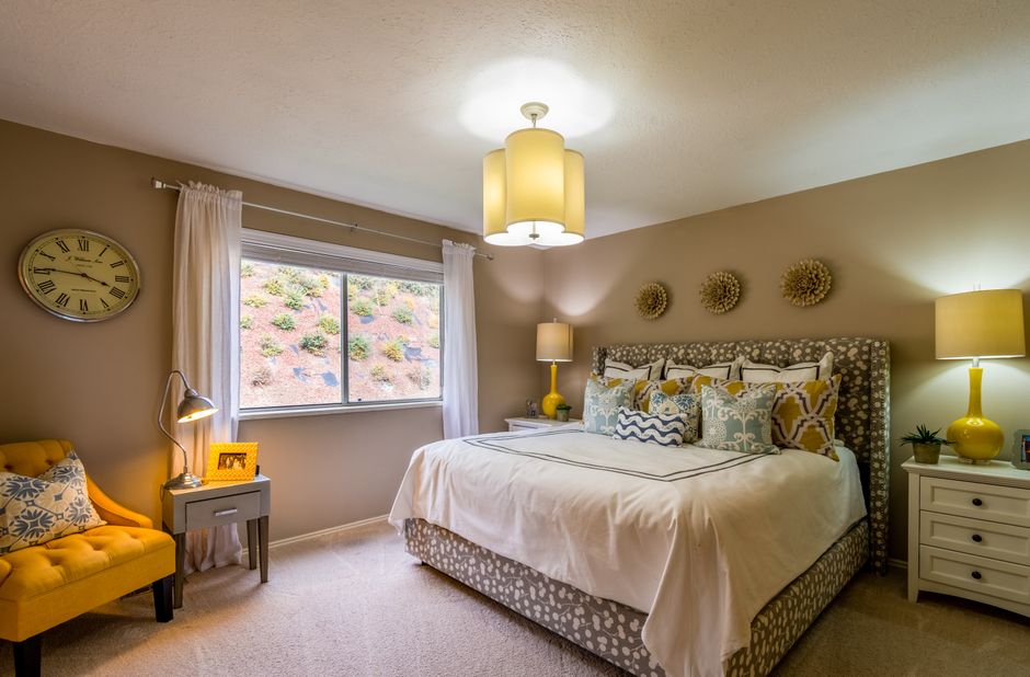 Spacious bedroom featuring modern decor with comfortable bedding and stylish lighting.