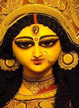 Detailed close-up of a traditional Hindu goddess statue, showcasing intricate artistry.