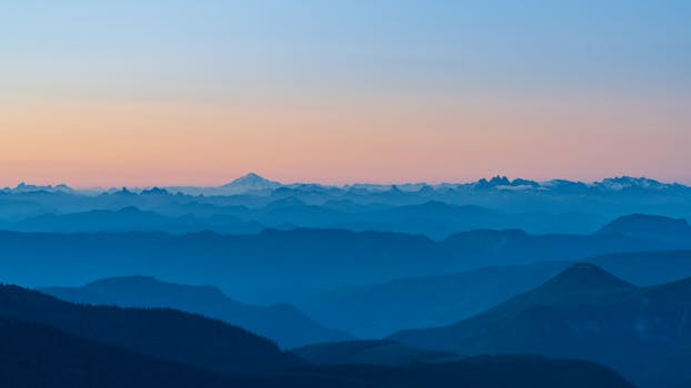 Capture of a tranquil mountain landscape at dusk with ambient twilight hues.