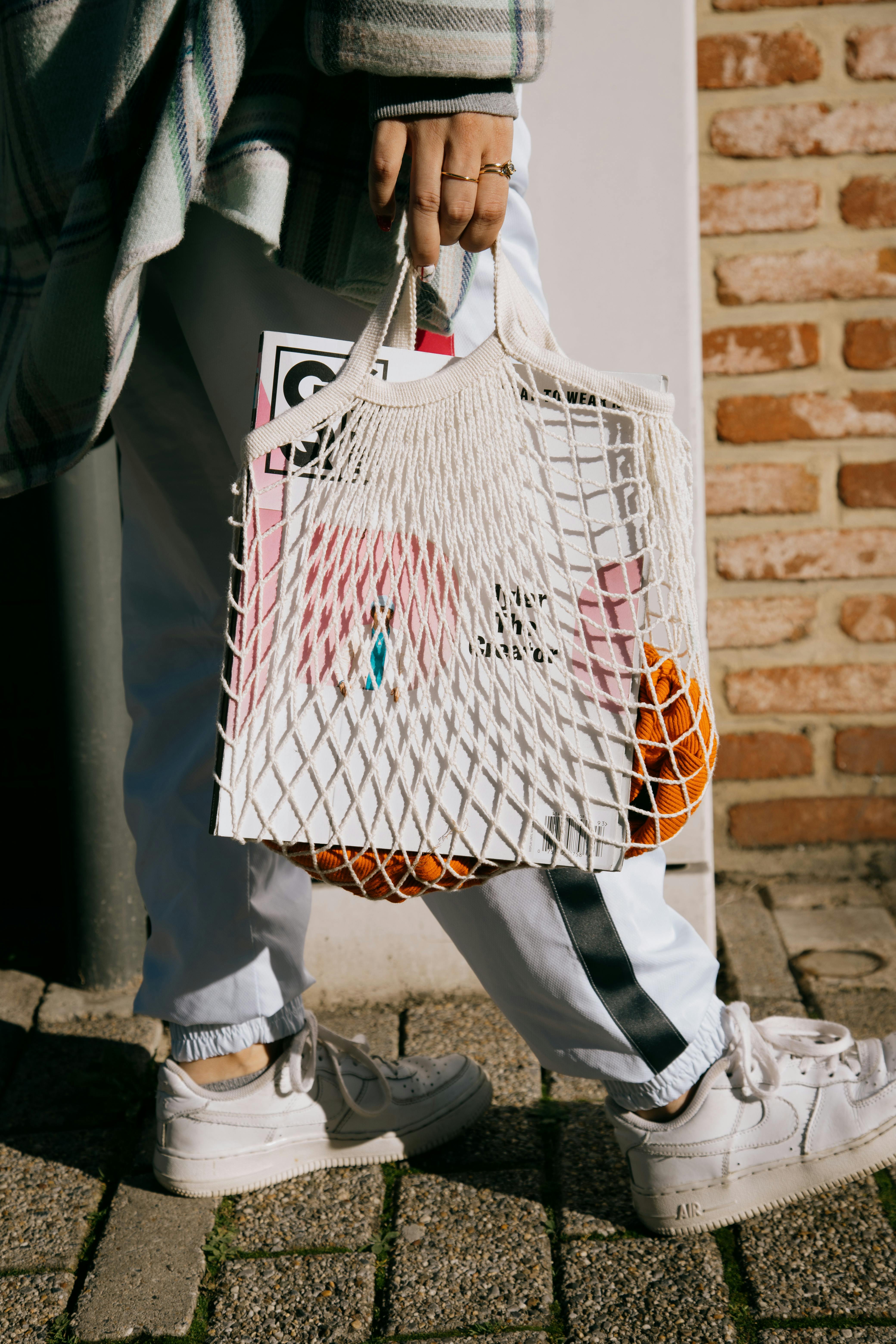 crop woman walking with shopping bag