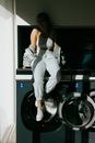 Happy woman sitting on washing machine