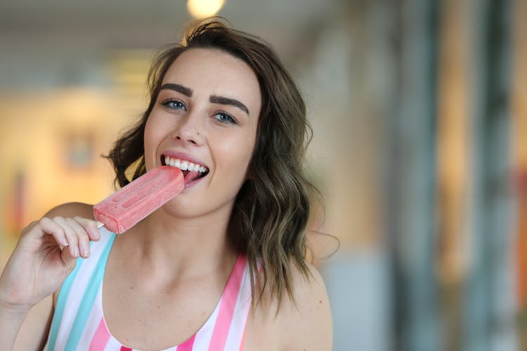 A Woman Eating A Popsicle 