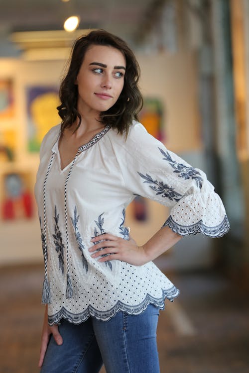 Free 
A Woman Wearing a Blouse and Denim Pants Stock Photo