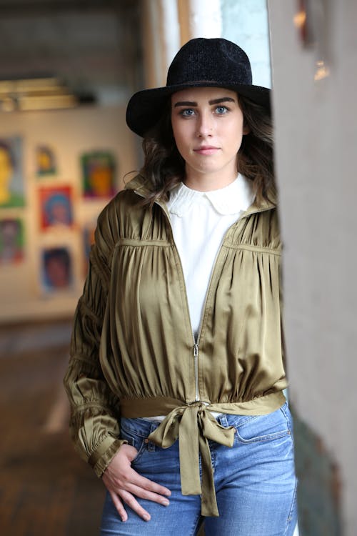 A Woman Wearing a Ruffle Jacket and Black Hat