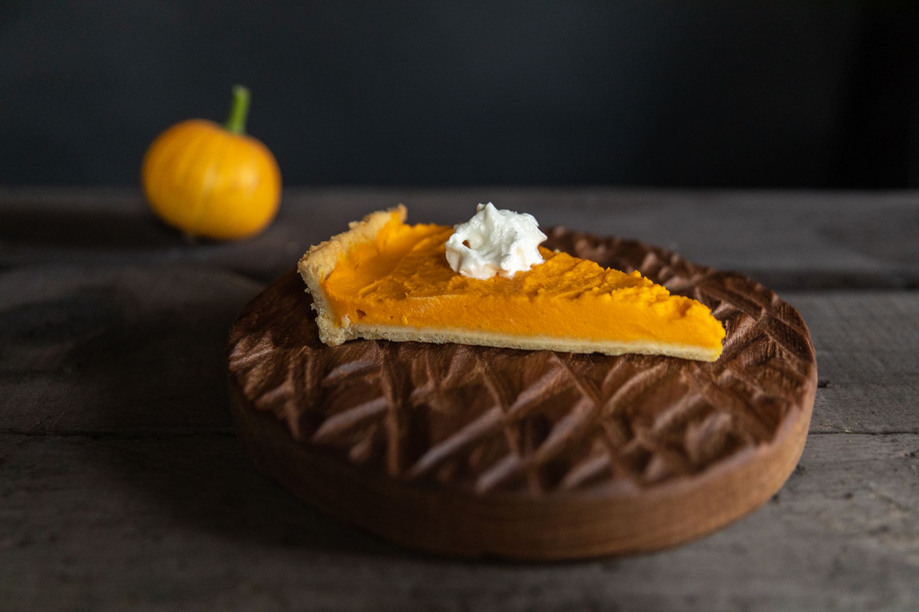 Slice of pumpkin pie with almond spiced whipped cream