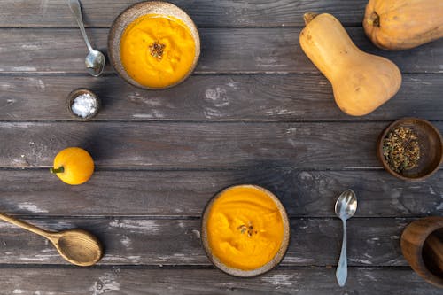 Free 
Bowls of Pumpkin Soup on a Wooden Surface Stock Photo
