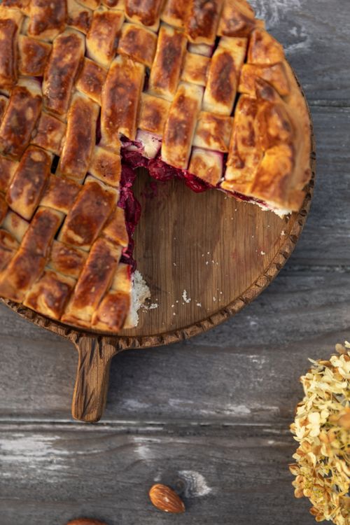 Free Delicious homemade berry pie with lattice crust on a rustic table, perfect for dessert lovers. Stock Photo