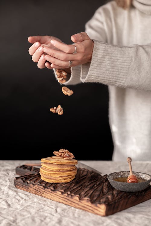 Free Person Putting Nuts On Pancakes Stock Photo