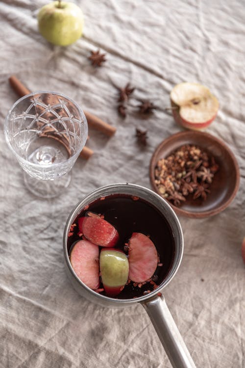 Slices of Apples Floating on a Red Liquid 