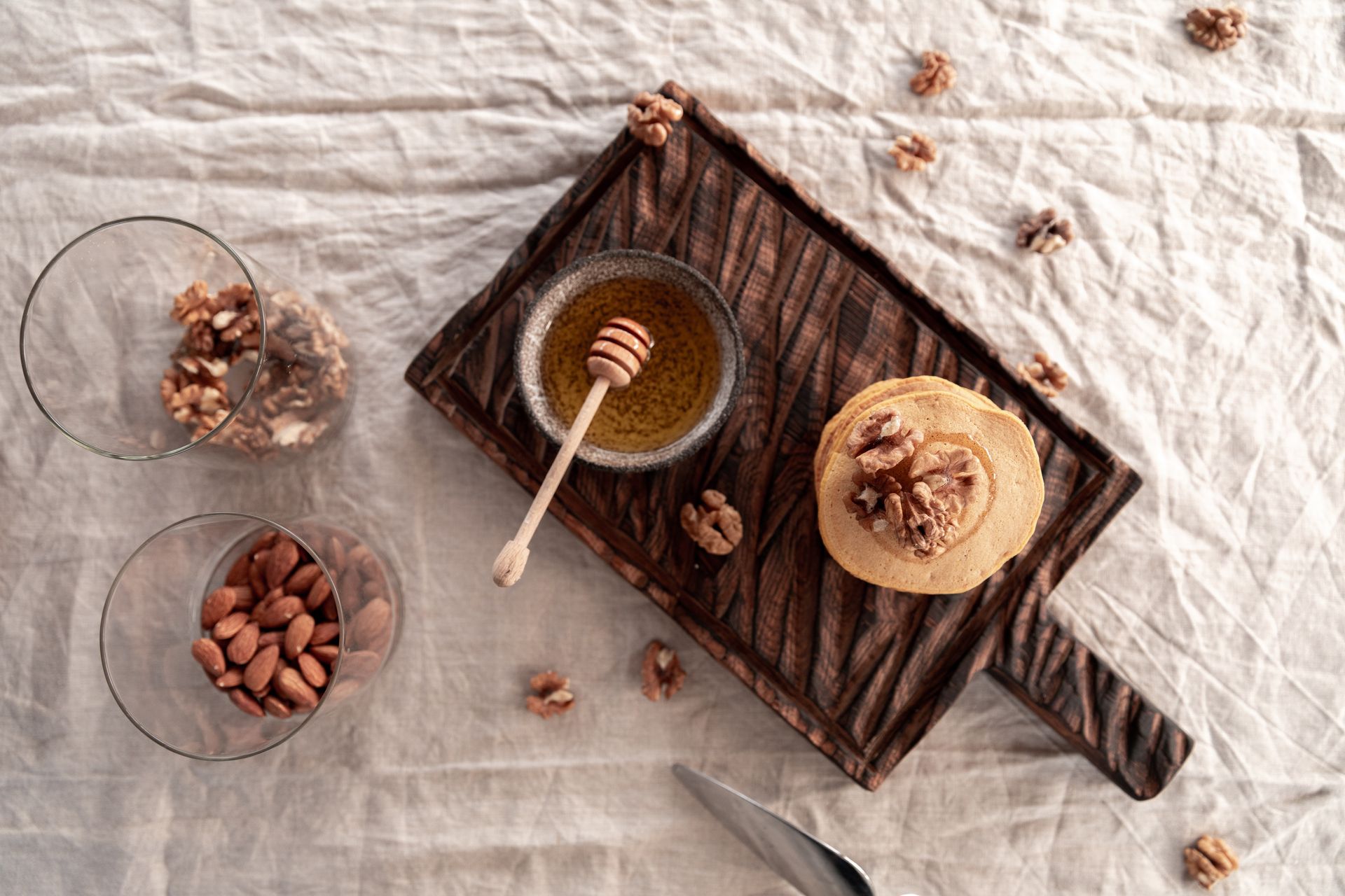 Pancakes and a Bowl of Honey on Wooden Board