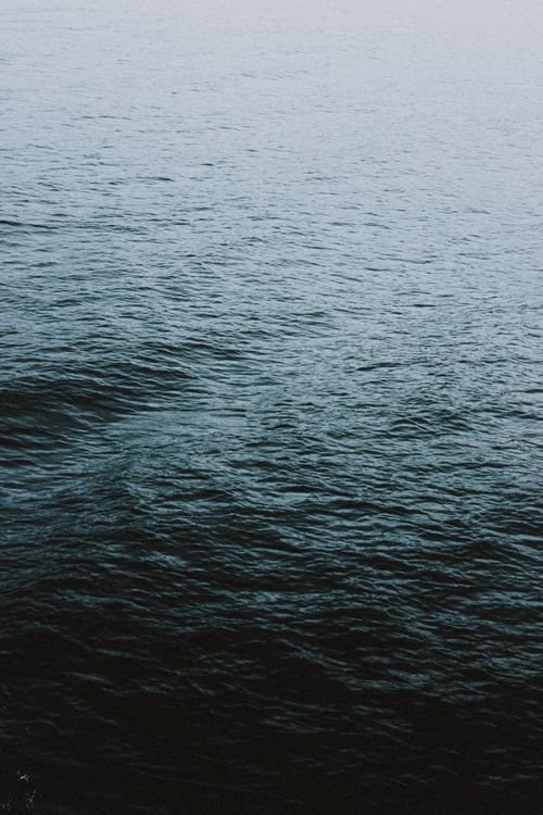 Free From above scenic view of rippled ocean with water flow in twilight on blurred background Stock Photo