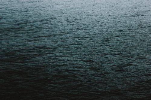 Free Abstract background of tranquil water of sea with slightly rippling surface in daylight Stock Photo