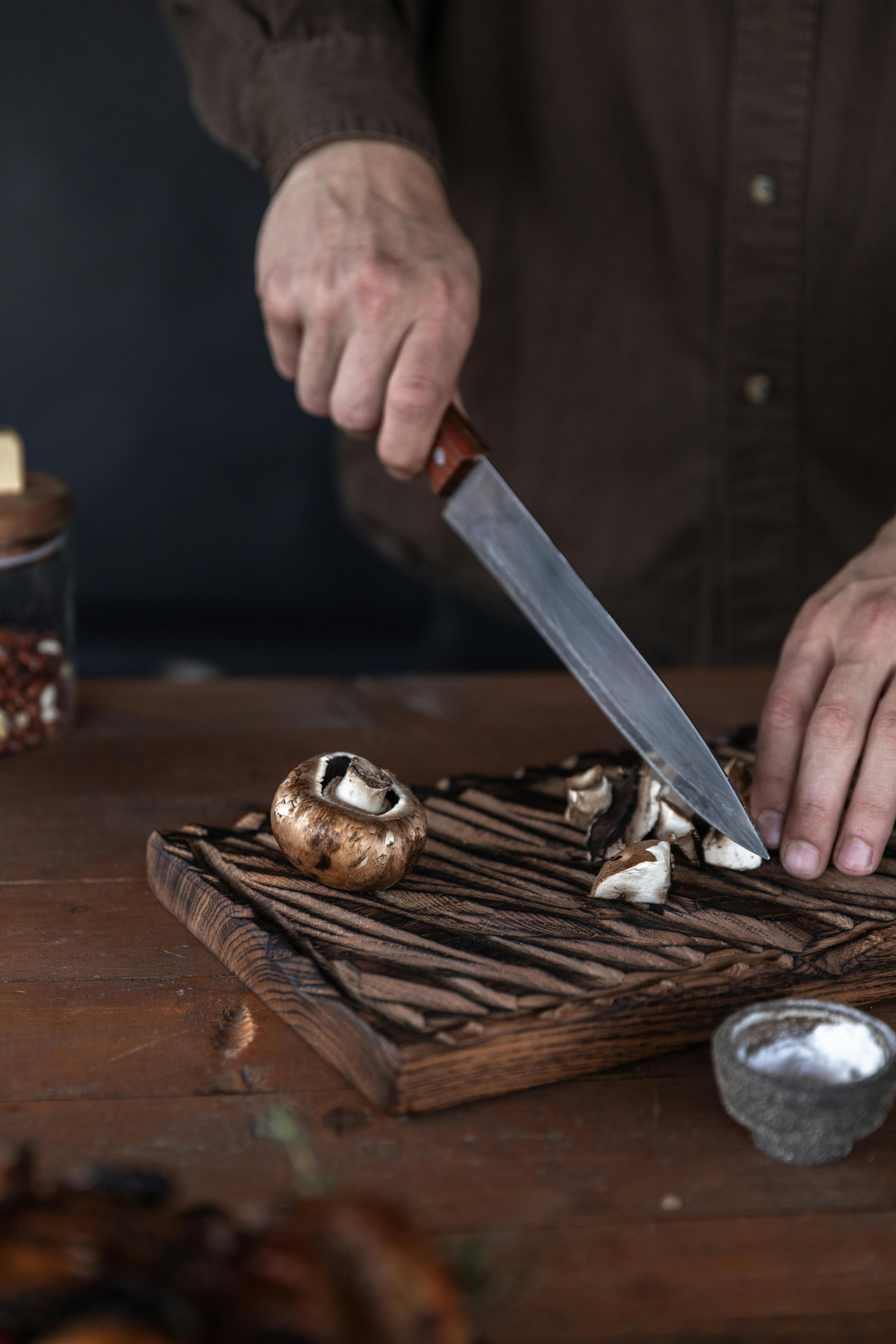 a person cutting a mushroom