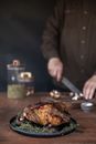 Person Slicing Meat on Brown Wooden Chopping Board